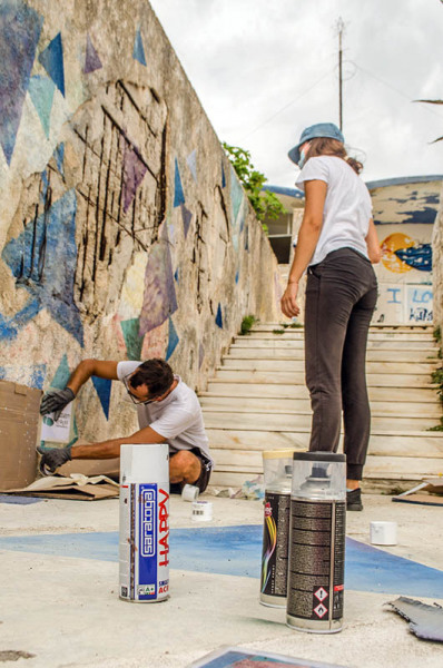 Ivan and Gulnaz stenciling the logo
